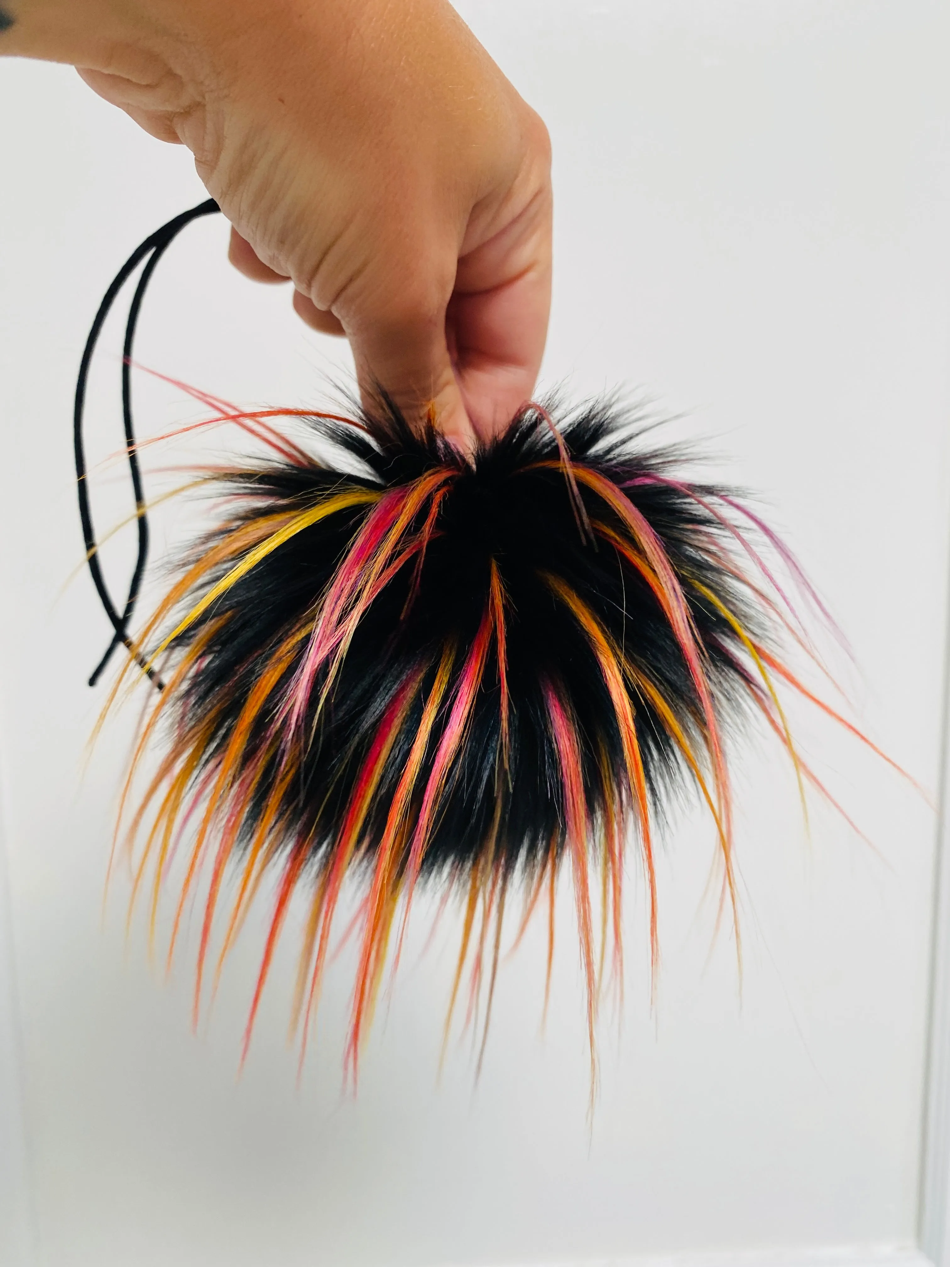 MADE TO ORDER Fun and funky black with long tips of yellow, red, pink, orange and purple faux fur pom pom with wooden button